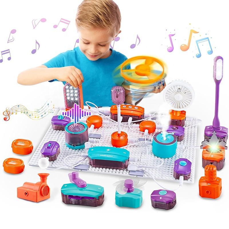 A little boy in a blue outfit is bent over playing with Science Education Electronic Building Blocks